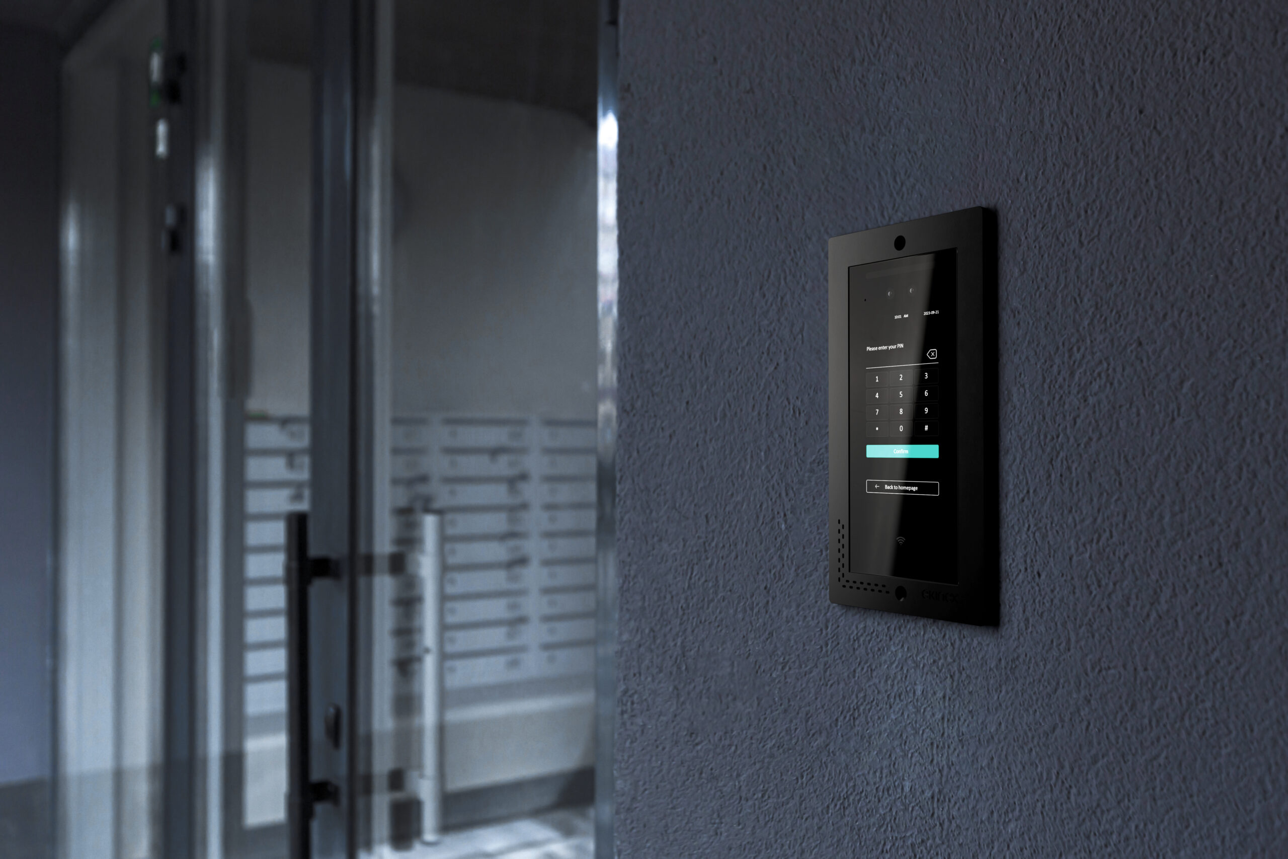 Entrance doorbell in a multi-apartment building, with a video surveillance camera, on a dark wall